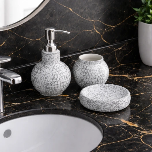 Speckled gray bathroom set on table.webp